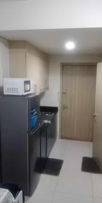 a small kitchen with a sink and a microwave at La Maison Breeze Residence in Manila
