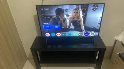 a flat screen tv sitting on top of a table at La Maison Breeze Residence in Manila