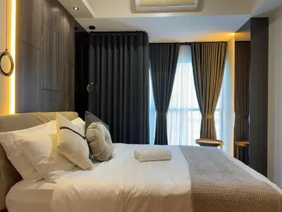 a bedroom with a large white bed with a window at Landscape view and sea view 1BR near Airport in Manila