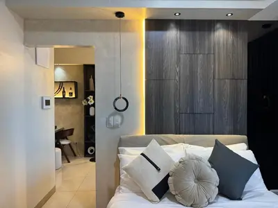 a bedroom with a white bed with blue pillows at Landscape view and sea view 1BR near Airport in Manila