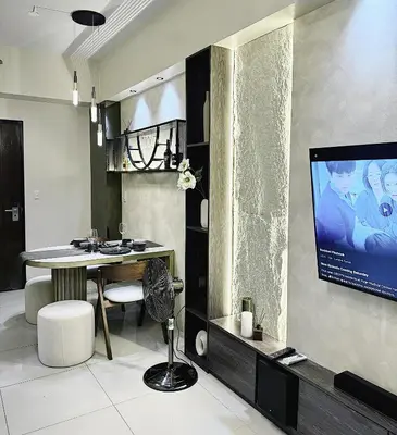 a living room with a television and a table and chairs at Landscape view and sea view 1BR near Airport in Manila