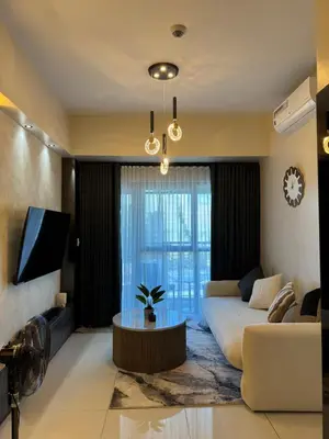 a living room with a couch and a tv at Landscape view and sea view 1BR near Airport in Manila
