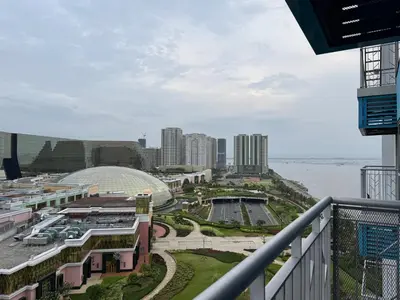 a view of a city from the balcony of a building at Landscape view and sea view 1BR near Airport in Manila