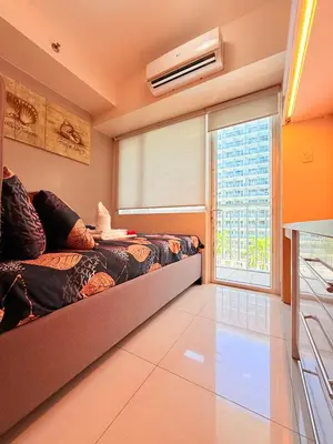 a bedroom with a bed and a large window at Shell Residences MOA Prime - Paul in Manila