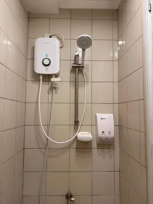 a shower in a bathroom with a hair dryer at Bachelor's Crib-1 Alabang in Manila