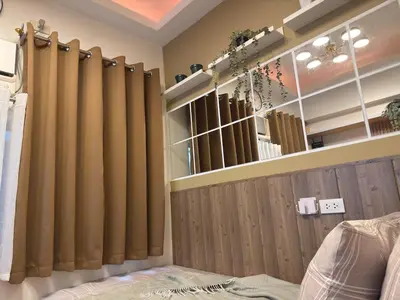 a room with brown curtains on a wall at Bachelor's Crib-1 Alabang in Manila
