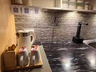 a kitchen counter with a jug of milk on it at Bachelor's Crib-1 Alabang in Manila