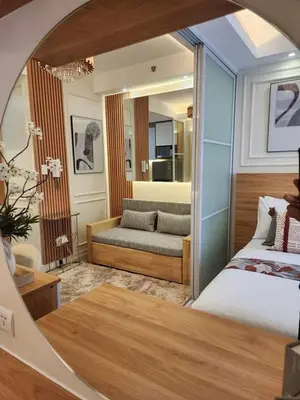a bedroom with a bed and a couch in a room at Exquisite space in Manila