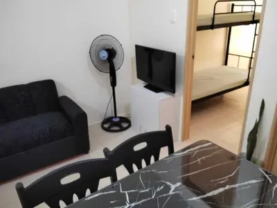 a living room with a couch and a television at Angels Pad in Manila