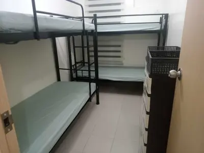 a small room with two bunk beds and a window at Angels Pad in Manila