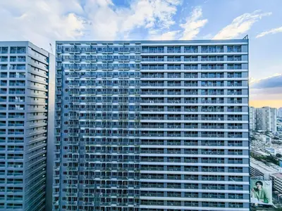 a tall building with many windows in a city at 1BR Condotel with Balcony at FAME Residences #FM08-1 in Manila