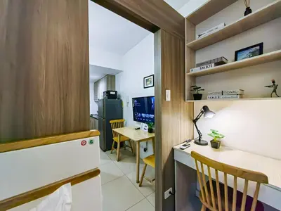 a small room with a desk and a table at 1BR Condotel with Balcony at FAME Residences #FM08-1 in Manila