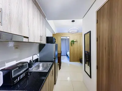 a kitchen with a sink and a counter top at 1BR Condotel with Balcony at FAME Residences #FM09-1 in Manila