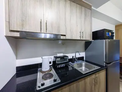 a kitchen with a sink and a counter top at 1BR Condotel with Balcony at FAME Residences #FM09-1 in Manila