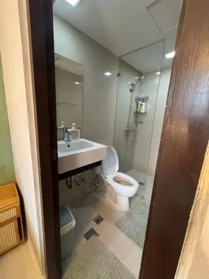 a bathroom with a toilet and a sink and a shower at Netflix and WiFi Staycation Viceroy Walk to Venice Grand Canal in Manila
