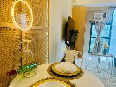 a dining room table with a plate of food on it at Netflix and WiFi Staycation Viceroy Walk to Venice Grand Canal in Manila