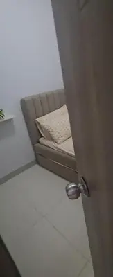 a brown couch sitting in a room at Coast Residences in Manila