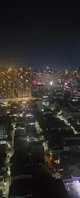a view of a city at night with lights at Coast Residences in Manila