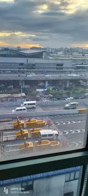 a view of a parking lot with cars and buses at Rqui Staycation Rooms Near Airports in Manila