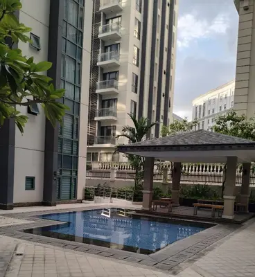 a swimming pool with a gazebo and buildings at Rqui Staycation Rooms Near Airports in Manila