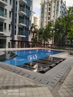 a swimming pool in a city with tall buildings at Rqui Staycation Rooms Near Airports in Manila