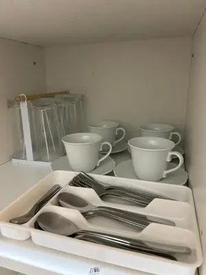 a white tray with silver utensils in a drawer at Vista gracia staycation in Manila