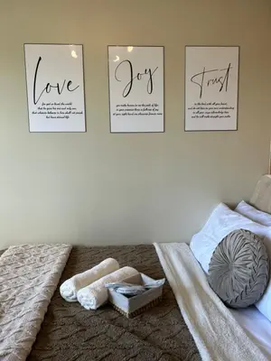 a bedroom with two posters on the wall and a bed at Vista gracia staycation in Manila