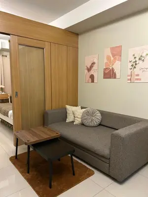 a living room with a couch and a table at Vista gracia staycation in Manila