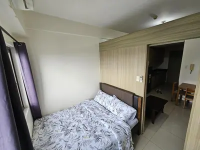 a small bedroom with a bed and a bathroom at Staycation near in Mall of Asia located in Shore1 and 2 Residences in Manila