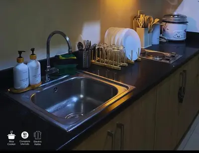a kitchen counter with a sink in a kitchen at Staycation near in Mall of Asia located in Shore1 and 2 Residences in Manila