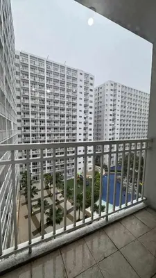 a balcony with a view of a large building at Staycation near in Mall of Asia located in Shore1 and 2 Residences in Manila