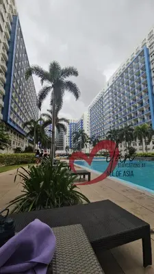 a view of a resort with a pool and buildings at Mall of Asia Sea Residences- Milan Staycations Casa Juan in Manila