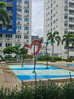 a sculpture in a pool in front of a building at Mall of Asia Sea Residences- Milan Staycations Casa Juan in Manila