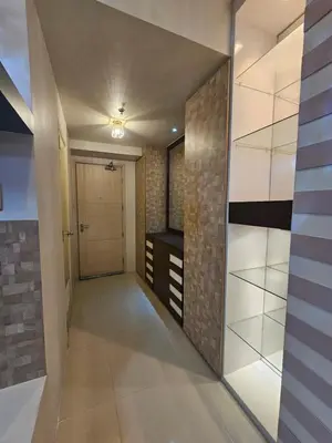 a hallway with a glass door and a walk in closet at Sea Residences Mall of Asia Viann in Manila