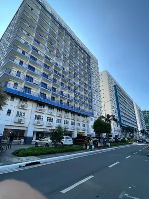 a large apartment building on the side of a street at Sea Residences Mall of Asia Viann in Manila