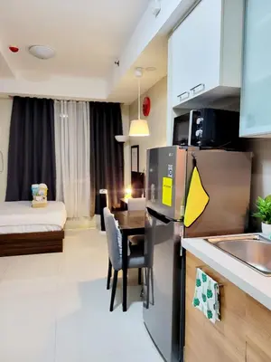 a room with a kitchen and a dining room at Cozy Condo near BGC and Ortigas with free Gym & Pool in Manila