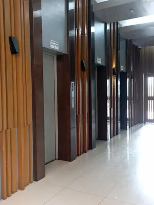 a row of wooden doors in a hallway at Cozy Condo near BGC and Ortigas with free Gym & Pool in Manila