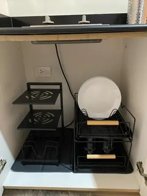 a white plate sitting on a shelf in a room at Cozy Staycation in Pasay in Manila