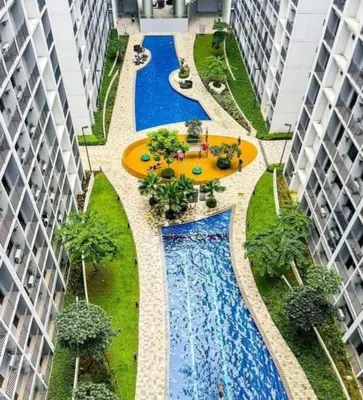 an overhead view of a swimming pool between two buildings at MOA Condotel in Mall of Asia located in Shore1 and 2 Residences in Manila