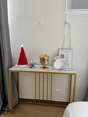 a table with a santa hat and other items on it at LuxeInn in Trece Martires