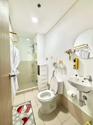 a bathroom with a toilet and a sink and a shower at LuxeInn in Trece Martires