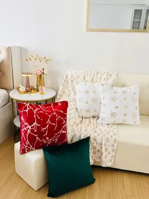 a living room with a white couch with pillows at LuxeInn in Trece Martires
