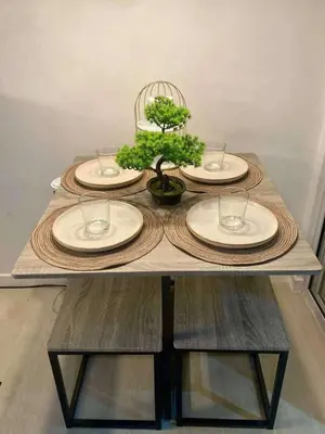 a table with plates and a potted plant on it at 1BR Condotel in Azure Urban Resort Near NAIA #TRO3 in Manila