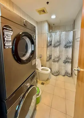 a washing machine in a bathroom with a toilet at 8 Adriatico Manila in Manila
