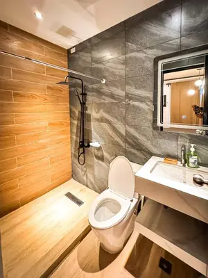 a bathroom with a toilet and a sink and a shower at 4BR Townhouse w Garage, Peaceful near Restaurants in Manila