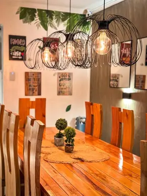 a dining room table with chairs and a chandelier at 4BR Townhouse w Garage, Peaceful near Restaurants in Manila