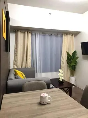 a living room with a table and a couch at Apartment in quezon city in Manila