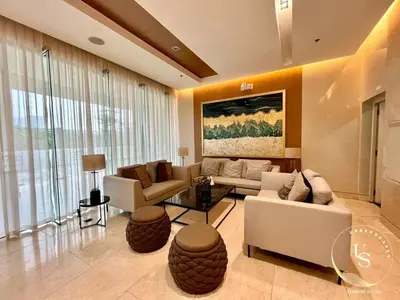 a living room with couches and chairs and a painting at Mall of Asia condotel shore 3 residence in Manila