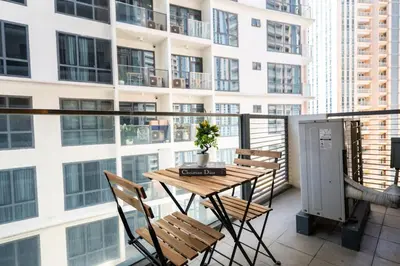 a balcony with a table and chairs and a building at Florence Mc Kinley Spacious 2 Bedroom, 2 balcony nr Mall, T3 airport in Manila