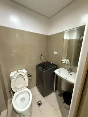 a bathroom with a toilet and a sink at LJ&LUNA Staycation in Manila
